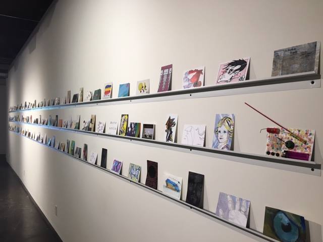 Long row of postcards on a wall